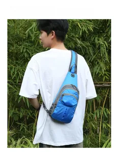 Detailed view of a blue and grey nylon cross-body hiking pack with multiple zippers