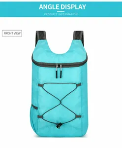 Front view of cyan lightweight packable backpack with grey elastic bungee cords and mesh straps