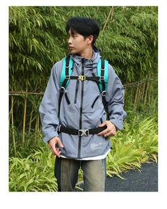 Detail of outdoor hiking backpack with chest straps and buckles against forest background