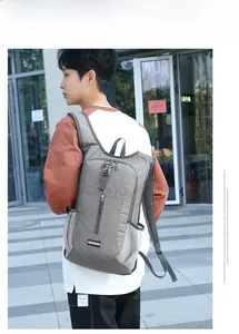 Side view of dark gray foldable outdoor backpack featuring padded honeycomb shoulder straps