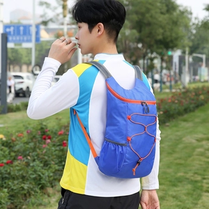 Lightweight blue folding outdoor backpack with orange zippers and elastic bungee cords