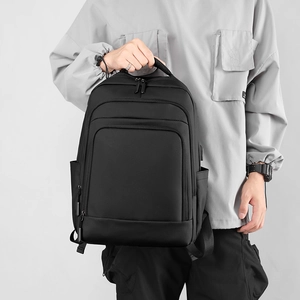 Minimalist black laptop backpack with USB charging port for business travel and daily commute