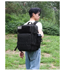 Detail view of black tactical backpack with MOLLE webbing and American flag patch