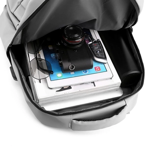 Gray business backpack with large capacity interior for laptop camera and essentials