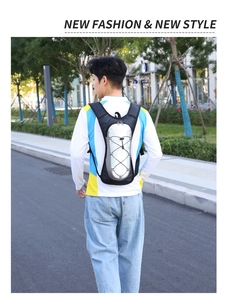 Outdoor hydration backpack with crisscross elastic cords shown on a male runner