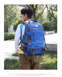 Detailed view of the 60L hiking backpack with ergonomic straps on a male model