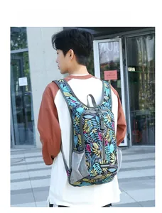Outdoor view of lightweight foldable cycling backpack with colorful leaf print and mesh pockets