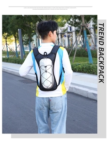 Outdoor cycling backpack with grey panel and elastic cords shown in an action street shot