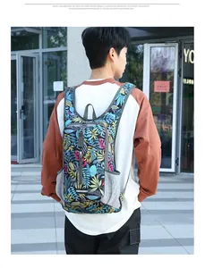 Detail of water-resistant cycling backpack featuring colorful tropical leaf patterns and side mesh