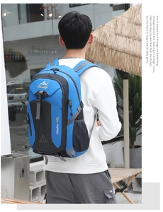 Detail view of the blue 40L hiking backpack with adjustable buckles and side mesh pockets
