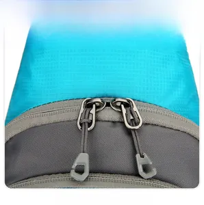 Close-up of sturdy double zippers on blue ripstop nylon hiking daypack with pull cords