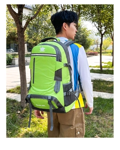 Detail view of a 60L hiking backpack in green and grey with tear-resistant nylon fabric