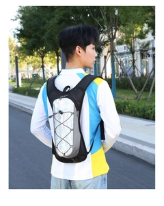 Detail of outdoor cycling backpack featuring a silver holographic panel and mesh straps