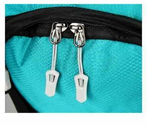 Macro detail of ripstop fabric and durable two-way zippers on the 60L hiking backpack