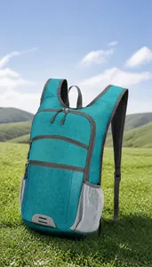 Detail view of lightweight foldable backpack with turquoise fabric and gray mesh pockets