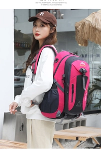 Detail showing pink 40L outdoor backpack with mesh side pockets and adjustable straps