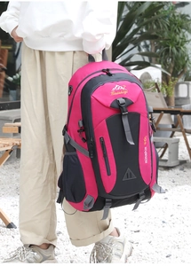 Detail of 40L outdoor hiking backpack in rose red and grey with buckles and mesh pockets