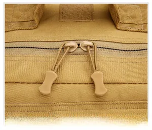 Detail of durable dual-way zippers with textured pullers on a khaki tactical backpack