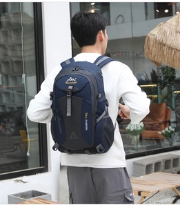 Rear view of a model wearing a 40L navy outdoor backpack showing fit and scale