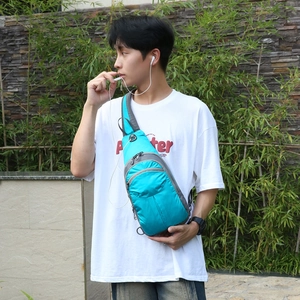 Blue and gray hiking daypack outdoor shoulder chest bag worn by a male model