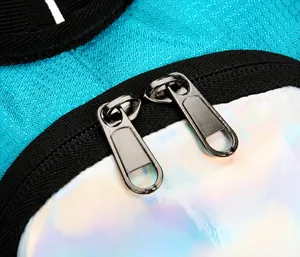 Close-up of durable dual metal zippers on a blue hiking backpack with holographic accents