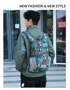 Outdoor backpack with tropical leaf print and padded straps shown on a male model