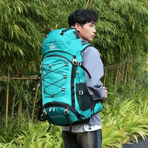Outdoor 60L hiking backpack in lake green shown on a model in a bamboo forest