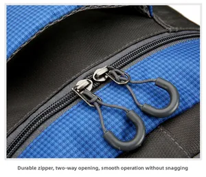Close-up of durable dual zippers with anti-slip pullers on blue ripstop hiking backpack