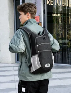Side view of a durable black hiking backpack with mesh pockets on a male model