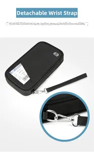 Detail showing the removable wrist strap with silver hardware hook on travel passport bag
