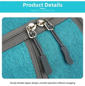 Close-up of durable dual metal zippers with ergonomic pull cords on teal outdoor backpack