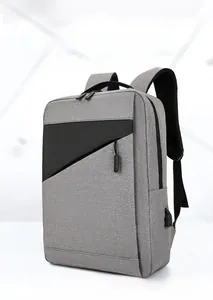 Detail of grey laptop backpack showing side USB charging port and anti-scratch fabric