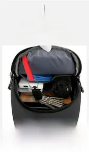 Detail view showing organized interior of black sling bag with tablet and umbrella storage