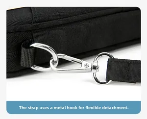 Detail of the durable silver metal hook and black canvas strap on the passport bag