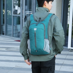 Lightweight foldable outdoor backpack for hiking and travel in a cyan water-resistant nylon