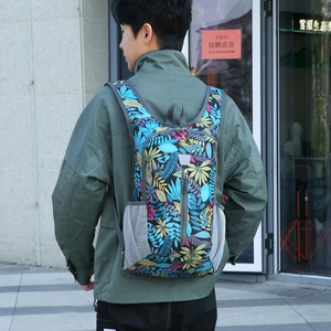 Foldable lightweight outdoor backpack with tropical leaf print and waterproof nylon fabric