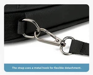 Close-up of a gunmetal swivel hook and D-ring on a durable black nylon travel bag