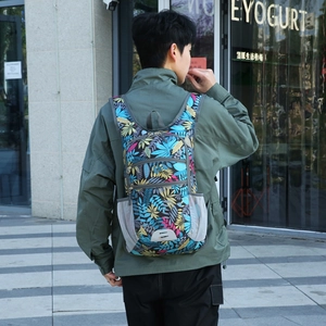 Water-resistant outdoor hiking backpack with colorful tropical leaf print and large capacity