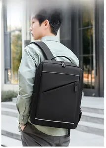 Business laptop backpack in black with reflective strips shown on model outdoors