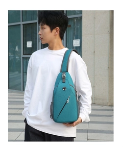Close-up of blue crossbody sling bag for men with earphone jack and mesh side pocket