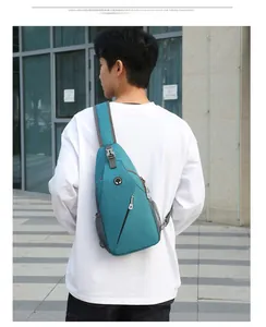 Detail view of a green sport chest bag with a headphone jack and mesh side pocket
