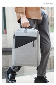 Detailed side view of gray business backpack with ergonomic handle and geometric texture