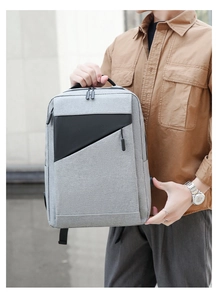 Detail view of gray tech fabric business backpack with black geometric patchwork and handle