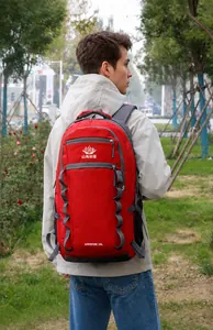 Close-up of a red 55L outdoor hiking backpack featuring adjustable side straps and zippers
