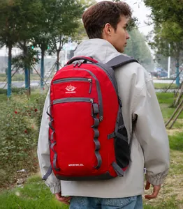 Outdoor 55L hiking backpack in red and grey shown on a person in a nature setting