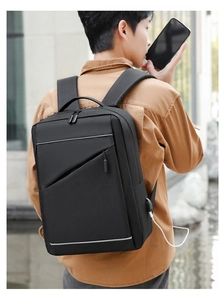Detail of laptop backpack showing reflective strip and side USB charging port in use