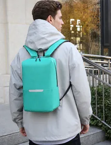 Detail of teal laptop backpack with reflective safety strip on outdoor model