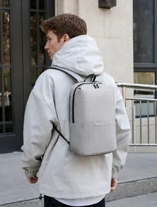 Light grey lightweight backpack with reflective strip and minimalist zipper pockets