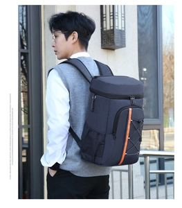Detail of insulated backpack featuring orange stripe accents and elastic bungee cords