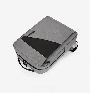 Flat lay detail showing the grey fabric texture and black leather accents of a business backpack